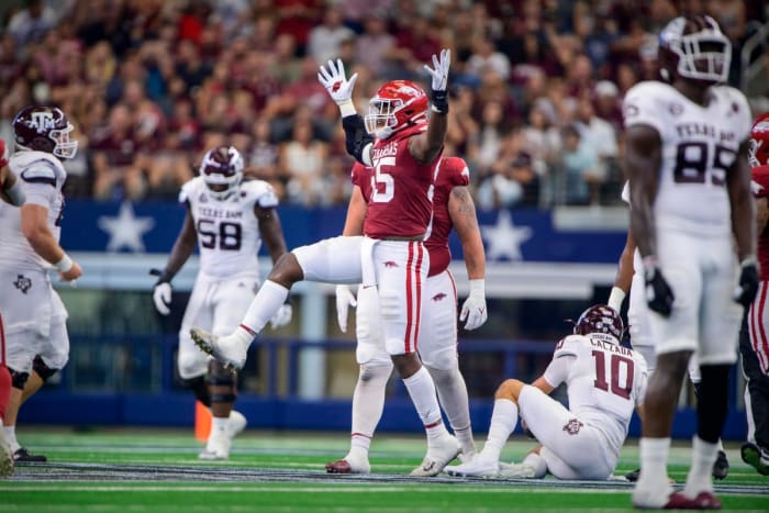 Sep 25, 2021; Arlington, Texas, USA; Arkansas Razorbacks defensive lineman Tre Williams (55) celebrates a sack of Texas A&M Aggies quarterback Zach Calzada (10) during the second quarter at AT&T Stadium. Mandatory Credit: Jerome Miron-USA TODAY Sports